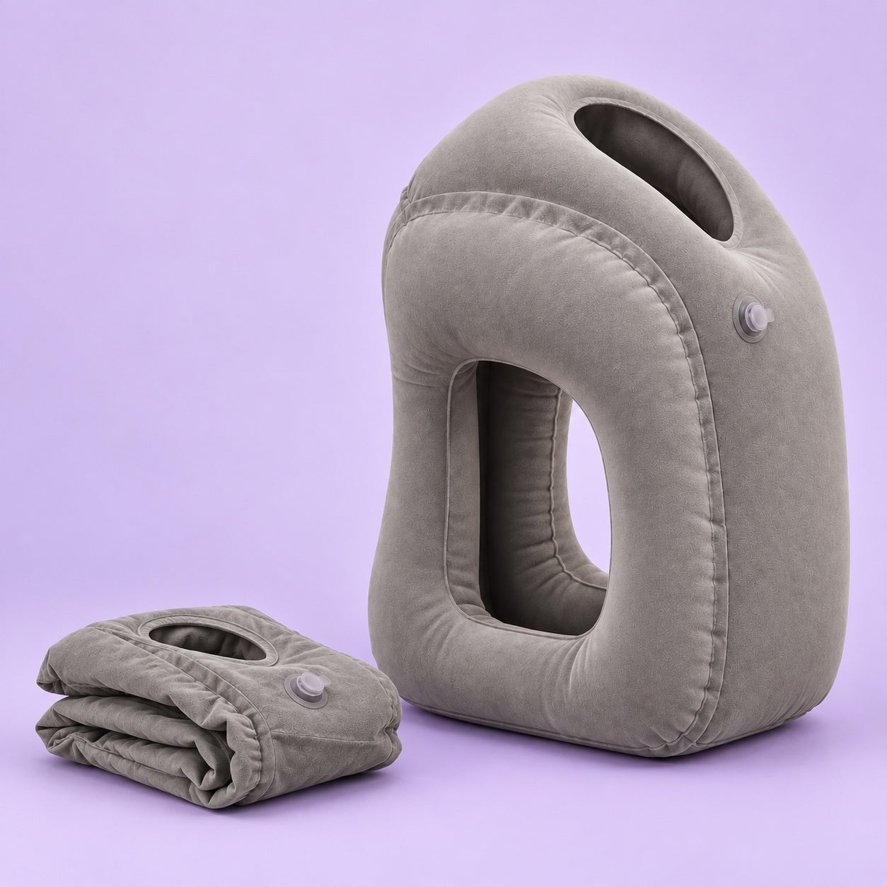 Grey inflatable pillow beside its folded version on a soft lilac background
